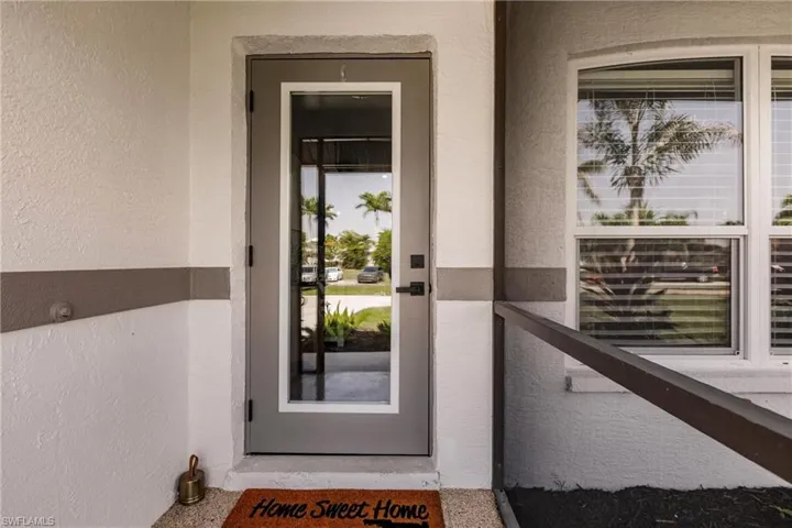 View of exterior entry featuring stucco siding