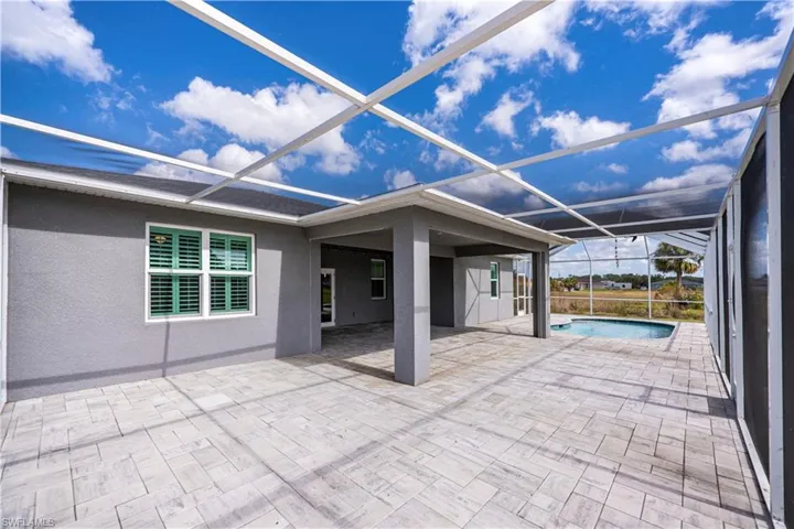 View of patio / terrace featuring an outdoor pool and a lanai