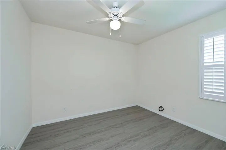 Empty room with wood finished floors and ceiling fan