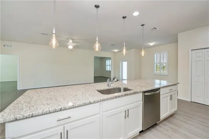 Kitchen featuring ceiling fan, light wood-type flooring, dishwasher, healthy amount of natural light, and recessed lighting