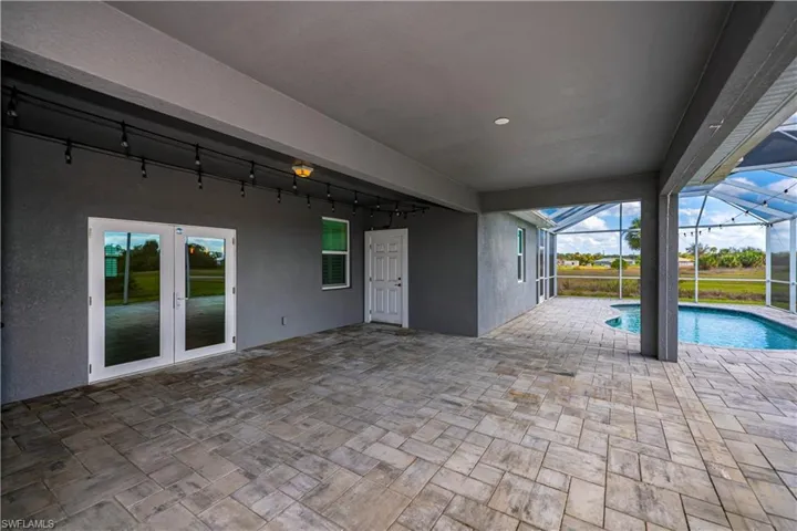 View of patio / terrace with french doors, a lanai, and an outdoor pool