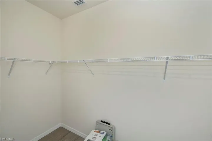 Spacious closet featuring wood finished floors