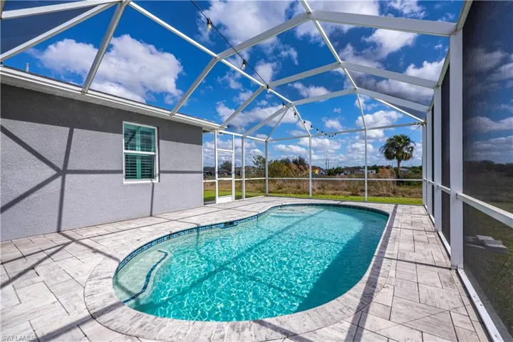Outdoor pool with a patio area and a lanai