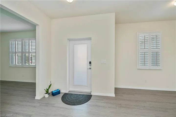 Entryway featuring wood finished floors and baseboards