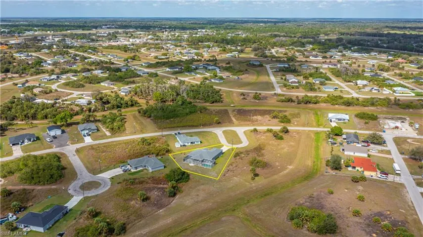 Aerial view of property's location featuring nearby suburban area