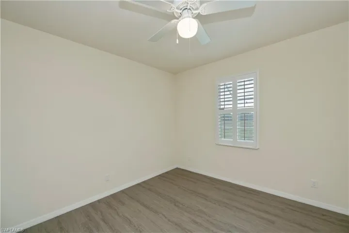 Spare room featuring wood finished floors and a ceiling fan