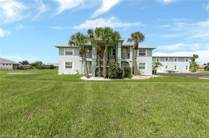 View of front of house featuring a front yard and a balcony
