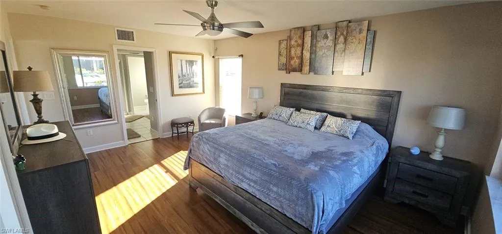 Bedroom with dark wood finished floors and a ceiling fan