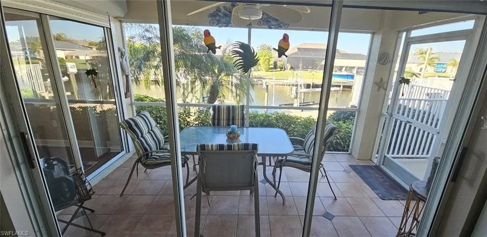 Sunroom featuring healthy amount of natural light and a water view