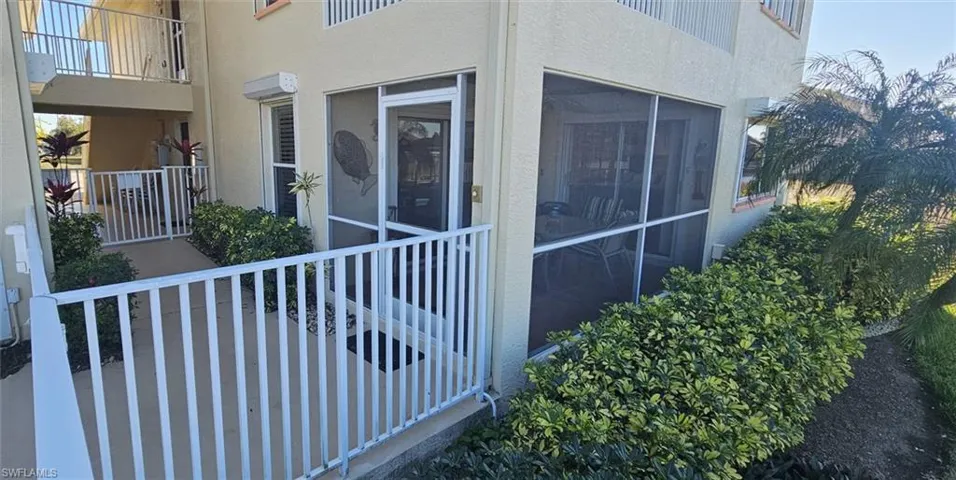 View of side of property with stucco siding and a sunroom