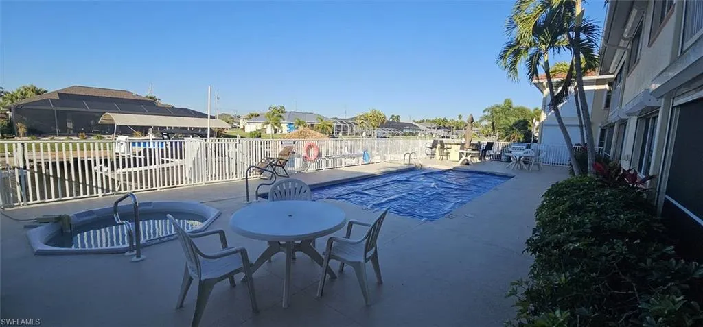 Community pool featuring a patio area and a residential view