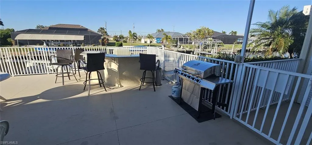 View of patio with a grill and a residential view