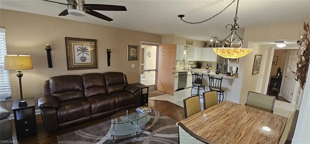 Living room featuring ceiling fan and light wood-style flooring