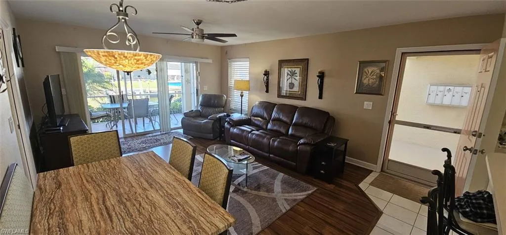 Living room with ceiling fan and light wood-style flooring
