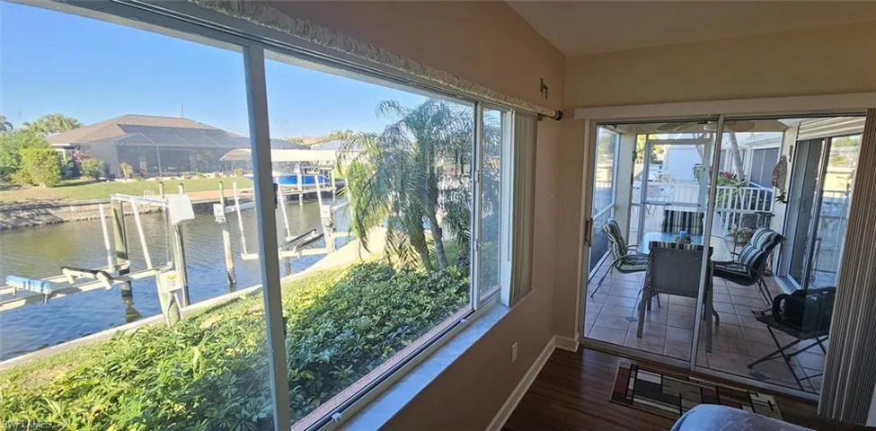 Sunroom / solarium featuring a water view and healthy amount of natural light