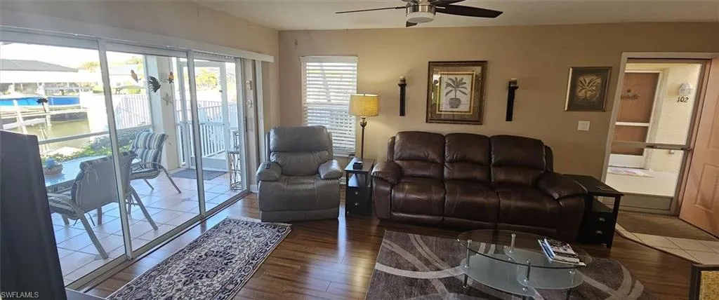 Living area with wood finished floors and a ceiling fan