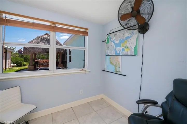 Living area with baseboards and light tile patterned flooring