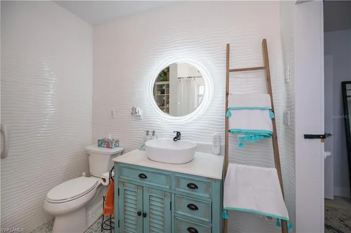 Full bath featuring vanity and tile walls