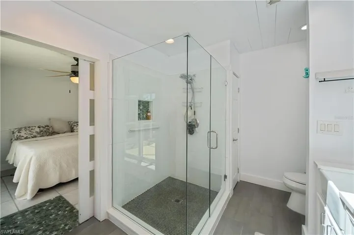 Full bath featuring ensuite bath, a shower stall, tile patterned floors, vanity, and recessed lighting