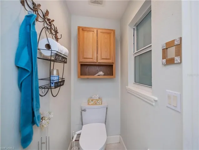 Bathroom with baseboards and tile patterned floors