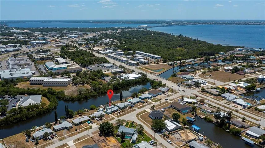 View of property location with a large body of water and nearby suburban area