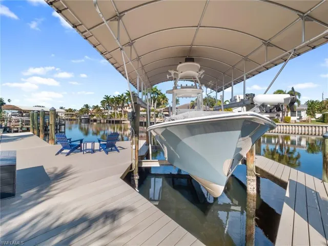 Dock with boat lift and a water view