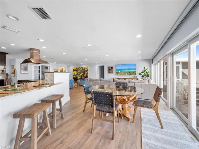 Dining area featuring light wood finished floors and recessed lighting