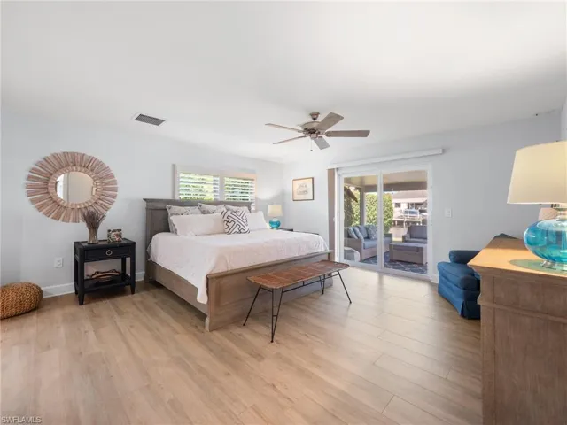 Bedroom featuring access to outside, light wood-type flooring, and ceiling fan