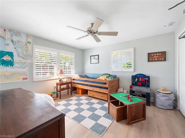 Rec room with a ceiling fan, light wood finished floors, and plenty of natural light