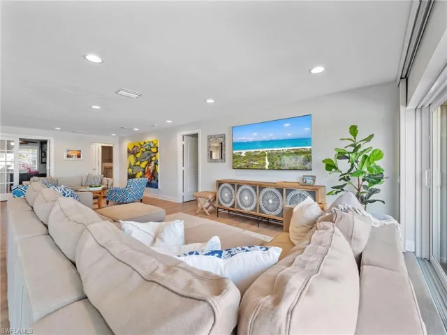 Living room with wood finished floors and recessed lighting