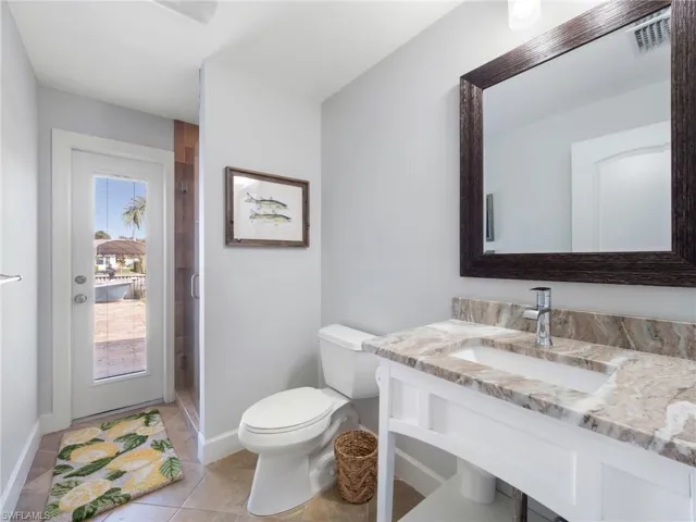 Full bath featuring a stall shower, vanity, and light tile patterned flooring