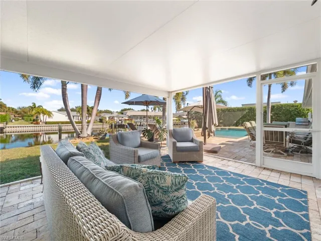 View of patio / terrace featuring a water view, outdoor lounge area, and a grill