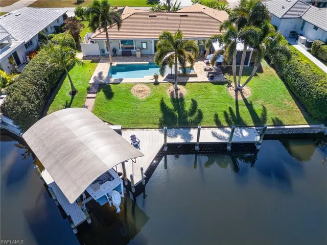 Aerial view of property and surrounding area featuring a nearby body of water