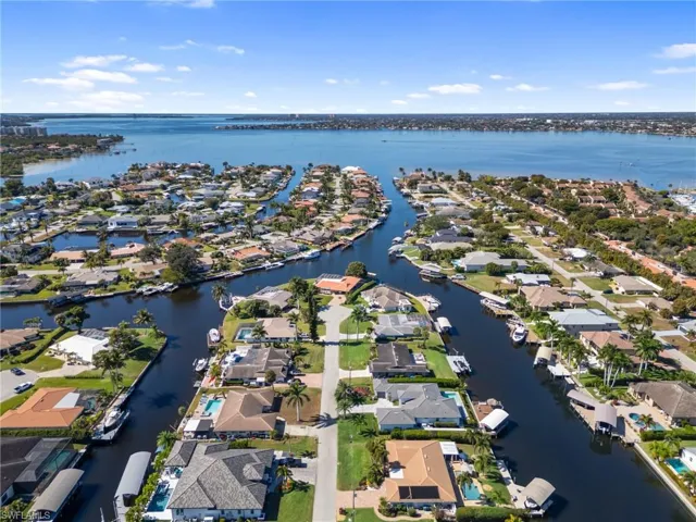 Aerial view of property's location with nearby suburban area