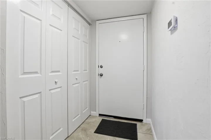 Doorway featuring tile patterned floors