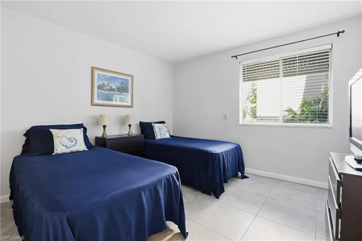 Bedroom featuring baseboards and light tile patterned flooring