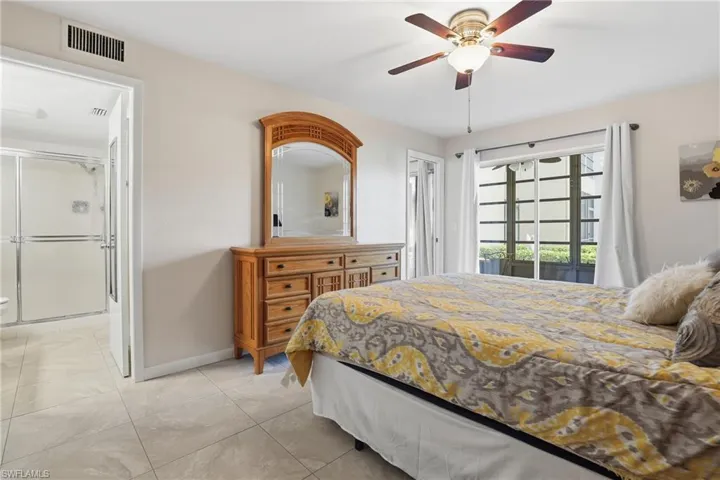 Bedroom featuring a ceiling fan, access to exterior, and light tile patterned floors