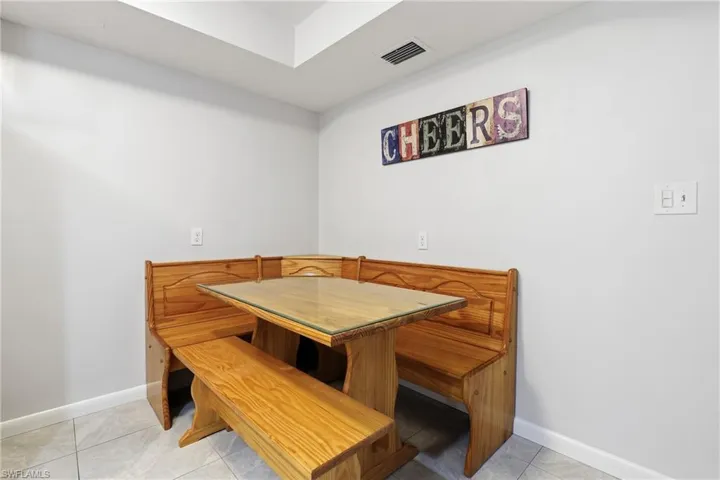 Dining room with light tile patterned floors and baseboards