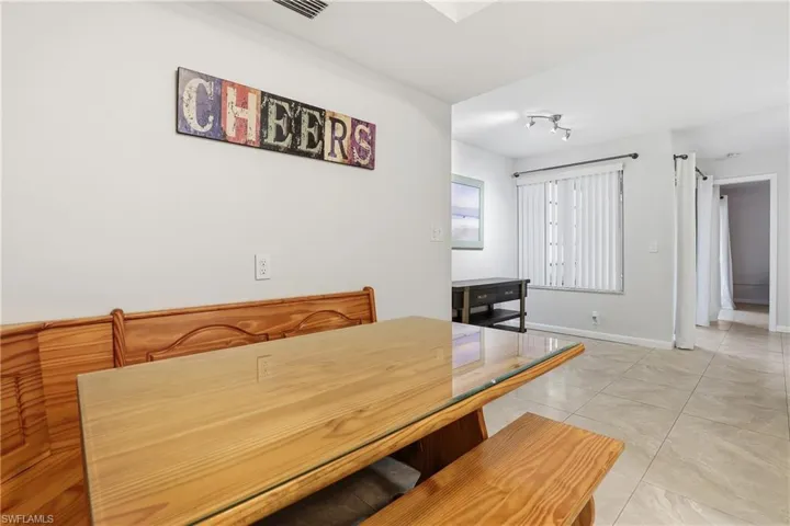 Dining space with light tile patterned floors and baseboards