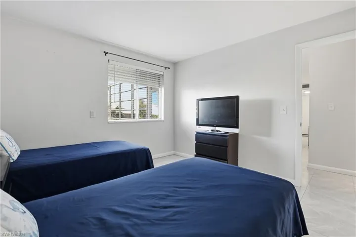 Bedroom featuring baseboards and light tile patterned flooring