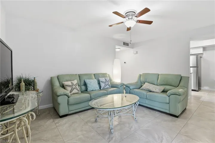 Tiled living area with a ceiling fan
