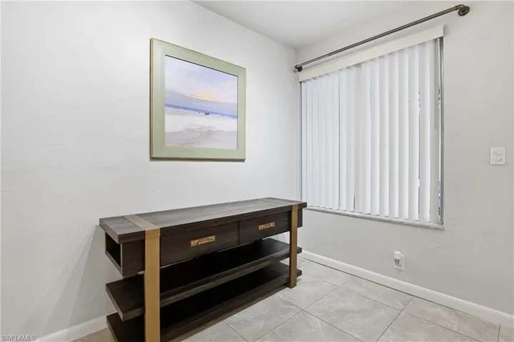 Unfurnished bedroom featuring multiple windows and light tile patterned flooring