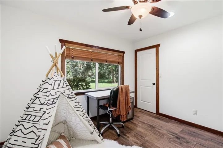 Additional bedroom with window, ceiling fan and neutral finishes