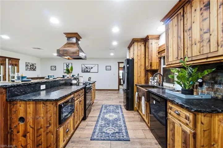 Additional kitchen view highlighting cabinetry, countertops and center island