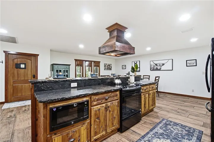 Kitchen  featuring extensive wood cabinetry and center island