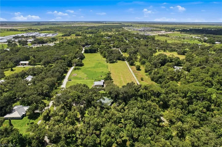 Wide aerial view of the residence and surrounding landscape