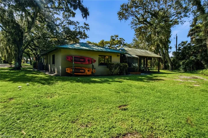 Rear exterior view showing the home and surrounding lawn