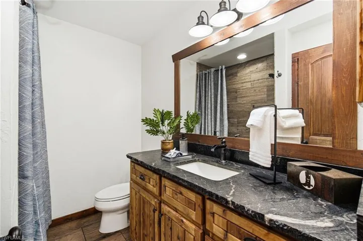 Guest bathroom with wood vanity with a shower/tub combination