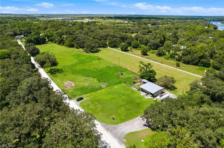 Aerial view highlighting the open grounds surrounding the residence
