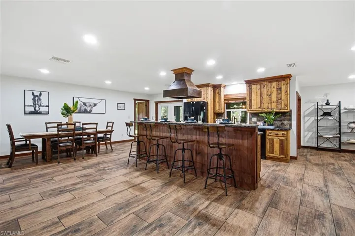 Wide angle view of the kitchen and adjoining open dining space